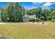 Spacious backyard with a basketball court, fire pit, and lush green lawn perfect for entertaining at 127 Muirwood Dr, Temple, GA 30179