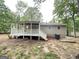 Charming home featuring a spacious backyard with a covered back porch at 3995 Willowbrook Dr, Douglasville, GA 30135