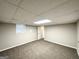 Finished basement area with neutral walls and carpet and door to another room at 3995 Willowbrook Dr, Douglasville, GA 30135