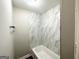 Clean bathroom featuring marble-look tile surround, a soaking tub, and modern fixtures at 3995 Willowbrook Dr, Douglasville, GA 30135