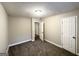 Neutral bedroom showing plush carpeting and a white door leading to other rooms at 3995 Willowbrook Dr, Douglasville, GA 30135