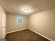 Neutral bedroom with a window bringing in natural light and plush, neutral carpeting at 3995 Willowbrook Dr, Douglasville, GA 30135