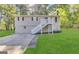 Inviting two-story home with a well-maintained lawn, complemented by a stairway leading to the front door at 3995 Willowbrook Dr, Douglasville, GA 30135