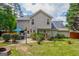 A two-story home displays a spacious backyard with a patio, green grass, and tasteful landscaping at 2060 Lake St, Loganville, GA 30052