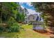 A large backyard features tasteful landscaping, a fire pit, a trampoline, and an outdoor dining area at 2060 Lake St, Loganville, GA 30052