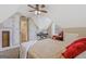Cozy bedroom with a piano, dormer windows, and warm lighting at 2060 Lake St, Loganville, GA 30052