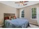 Inviting bedroom featuring a queen bed, ceiling fan, and plenty of natural light at 2060 Lake St, Loganville, GA 30052