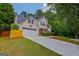 Side view of a two-story home with a well-manicured lawn and a two car garage at 2060 Lake St, Loganville, GA 30052
