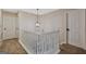 Open hallway shows a white stairwell and a decorative light fixture at 2060 Lake St, Loganville, GA 30052
