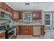 Kitchen with wood cabinetry, stainless steel appliances and bright lighting at 2060 Lake St, Loganville, GA 30052