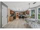 Spacious kitchen with dark wood cabinets, stainless steel appliances and adjacent dining area at 2060 Lake St, Loganville, GA 30052