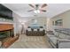 Cozy living room with a brick fireplace, ceiling fan, and comfortable seating at 2060 Lake St, Loganville, GA 30052