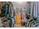 Walk-in closet with built-in shelving, rods and wooden dresser at 2060 Lake St, Loganville, GA 30052