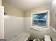 Bathroom featuring a tub, shower, white tile, and a window for natural light at 2610 Preston Dr, Decatur, GA 30034