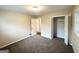 Bedroom with neutral walls, brown carpet, closet and bright natural light from the windows at 2610 Preston Dr, Decatur, GA 30034
