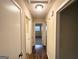 Hallway featuring hardwood floors and multiple doorways leading to various rooms at 2610 Preston Dr, Decatur, GA 30034