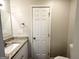 Bathroom features granite vanity, framed mirror, new toilet, towel hooks, and storage at 2930 Waters Rd, Atlanta, GA 30354