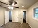 Bright bedroom features neutral walls, carpet flooring, a ceiling fan and two access doors at 2930 Waters Rd, Atlanta, GA 30354