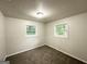 Bedroom featuring neutral walls, carpet, and natural light from two windows at 2930 Waters Rd, Atlanta, GA 30354
