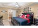 Bedroom with tray ceiling, teddy bear, and various framed photos on wall at 425 Wendy Ct, Mcdonough, GA 30252