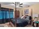 Comfortable bedroom with a four-poster bed and a decorative ceiling fan at 425 Wendy Ct, Mcdonough, GA 30252