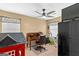 Office area with a desk, chair, and exercise equipment in a well-lit room at 425 Wendy Ct, Mcdonough, GA 30252