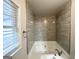 Soaking tub with a tiled surround offers a relaxing experience in this home at 660 Thomasville Se Blvd, Atlanta, GA 30315