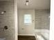 Renovated bathroom with gray tile shower and modern fixtures and finishes at 660 Thomasville Se Blvd, Atlanta, GA 30315