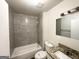 Bathroom featuring modern vanity, new toilet and shower and bath combo with stone-look shower walls at 660 Thomasville Se Blvd, Atlanta, GA 30315