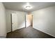 A room with neutral paint and carpet, featuring two doorways and ceiling light at 660 Thomasville Se Blvd, Atlanta, GA 30315