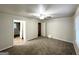 A room with neutral paint and carpet, featuring a ceiling fan and bathroom access at 660 Thomasville Se Blvd, Atlanta, GA 30315