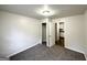A room with neutral paint and carpet, featuring a closet and doorway to kitchen at 660 Thomasville Se Blvd, Atlanta, GA 30315