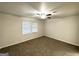 A room with neutral paint and carpet, featuring a window and ceiling fan at 660 Thomasville Se Blvd, Atlanta, GA 30315