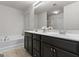 Bathroom featuring double sink vanity, soaking tub, and neutral color palette at 881 Whittington Sw Pkwy, Marietta, GA 30060