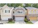 Charming townhome with a well-manicured lawn, attached garages, and a modern neutral color scheme at 881 Whittington Sw Pkwy, Marietta, GA 30060