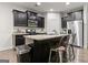 Stylish kitchen featuring an island with a sink, stainless steel appliances and dark cabinets at 881 Whittington Sw Pkwy, Marietta, GA 30060