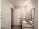 Bright bathroom featuring granite countertop vanity and wood-look flooring at 263 Coral Cir, Mcdonough, GA 30253