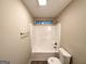 Bathroom featuring tub and shower combo with white tile and neutral walls at 263 Coral Cir, Mcdonough, GA 30253