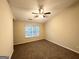 Spacious bedroom with carpet, ceiling fan, and large window offering natural light at 263 Coral Cir, Mcdonough, GA 30253
