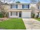 Charming two-story home with a well-manicured lawn and a one car garage at 263 Coral Cir, Mcdonough, GA 30253