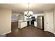 Open-concept kitchen with white cabinets, stainless steel appliances, and an island with granite countertops at 263 Coral Cir, Mcdonough, GA 30253