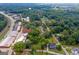 Scenic aerial view of the property surrounded by lush greenery and neighboring buildings in a charming neighborhood at 29 Indian Creek Rd, Locust Grove, GA 30248