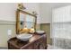 Bathroom featuring vintage fixtures, a large mirror, and natural light at 29 Indian Creek Rd, Locust Grove, GA 30248