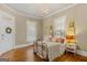 Cozy bedroom featuring natural light, hardwood floors, and decorative iron bed frame at 29 Indian Creek Rd, Locust Grove, GA 30248