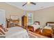 Bedroom featuring two beds, ceiling fan, hardwood floors, and bright natural light at 29 Indian Creek Rd, Locust Grove, GA 30248
