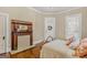 Comfortable bedroom with hardwood floors and a decorative fireplace with tile surround at 29 Indian Creek Rd, Locust Grove, GA 30248