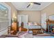 Charming bedroom with ceiling fan, hardwood floors, and bright natural light at 29 Indian Creek Rd, Locust Grove, GA 30248