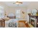 Bedroom featuring an antique fireplace, vintage metal bed, and hardwood floors at 29 Indian Creek Rd, Locust Grove, GA 30248