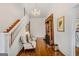 Bright entryway with wooden staircase, hardwood floors, fireplace, chandelier, and seating at 29 Indian Creek Rd, Locust Grove, GA 30248
