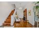 Elegant foyer featuring hardwood floors, staircase, chandelier, and a decorative fireplace with seating area at 29 Indian Creek Rd, Locust Grove, GA 30248